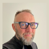 Richard Roche facing the camera in bold glasses