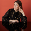 Ashley in front of burnt orange background
