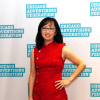 Judy wearing red and standing in front of the CAF banner
